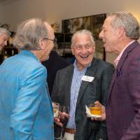 J.C. Huizenga standing and chatting with two other event guests